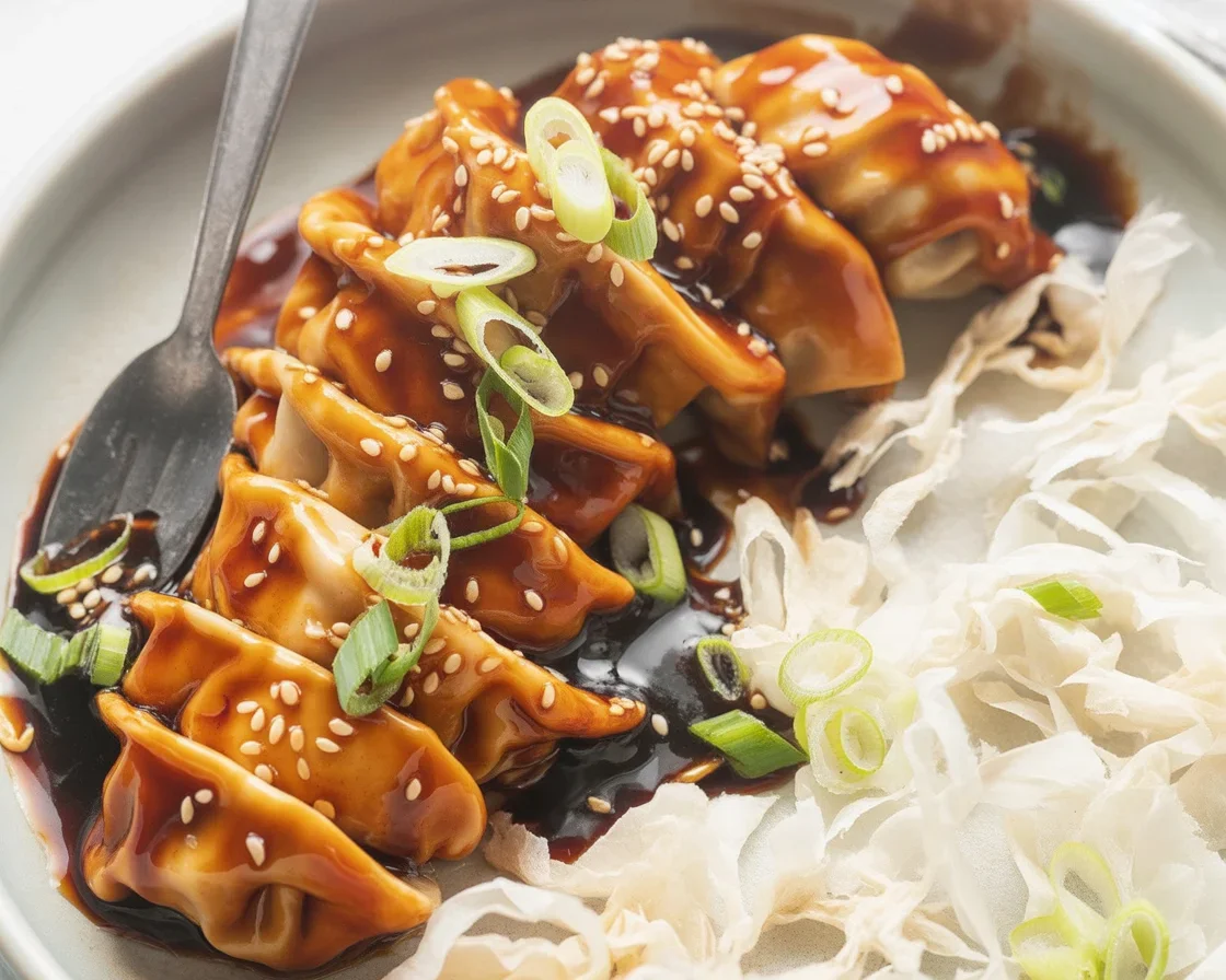 Baked chicken teriyaki served with a homemade teriyaki sauce and garnished with sesame seeds.